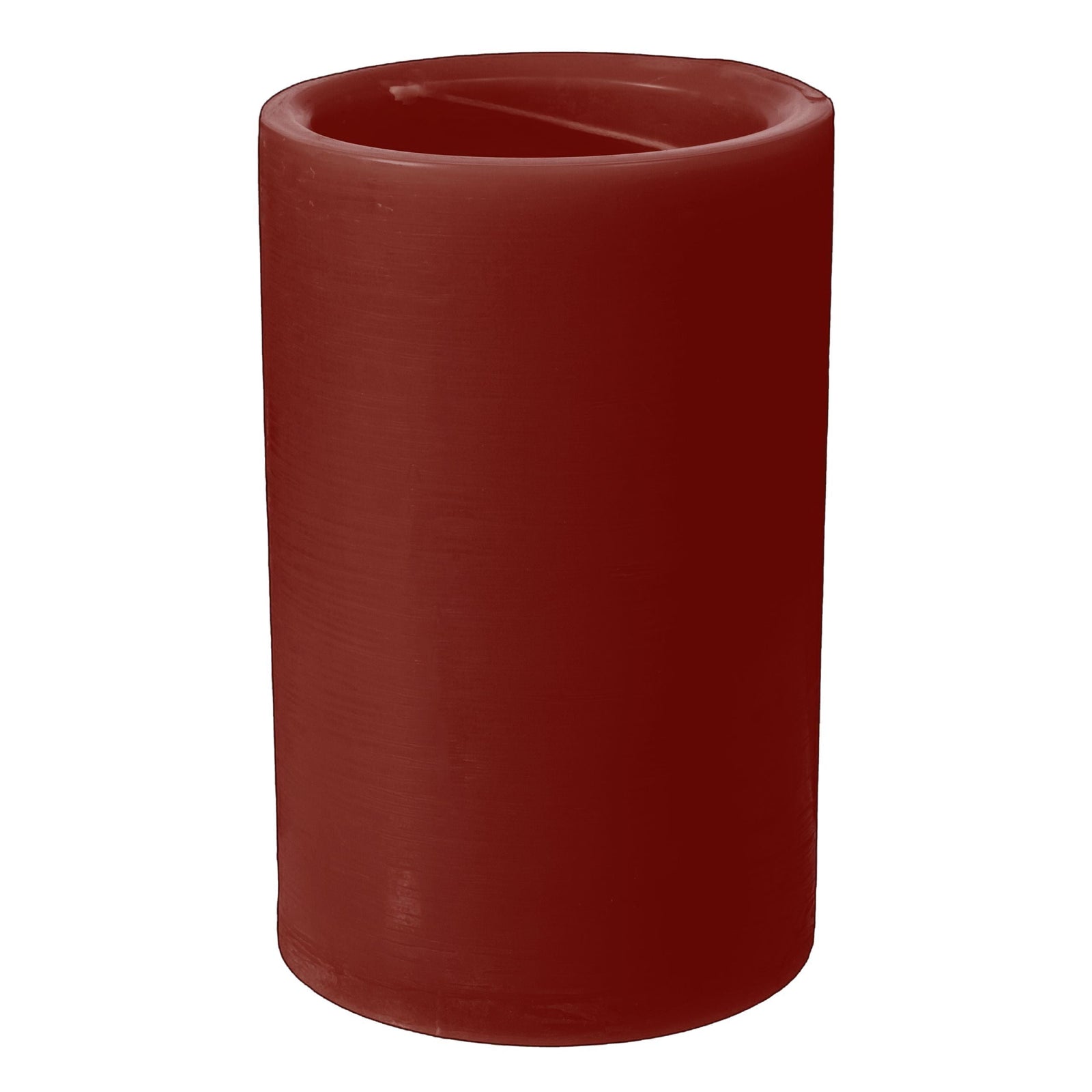 Red candle in a white holder on a textured surface with apples in the background